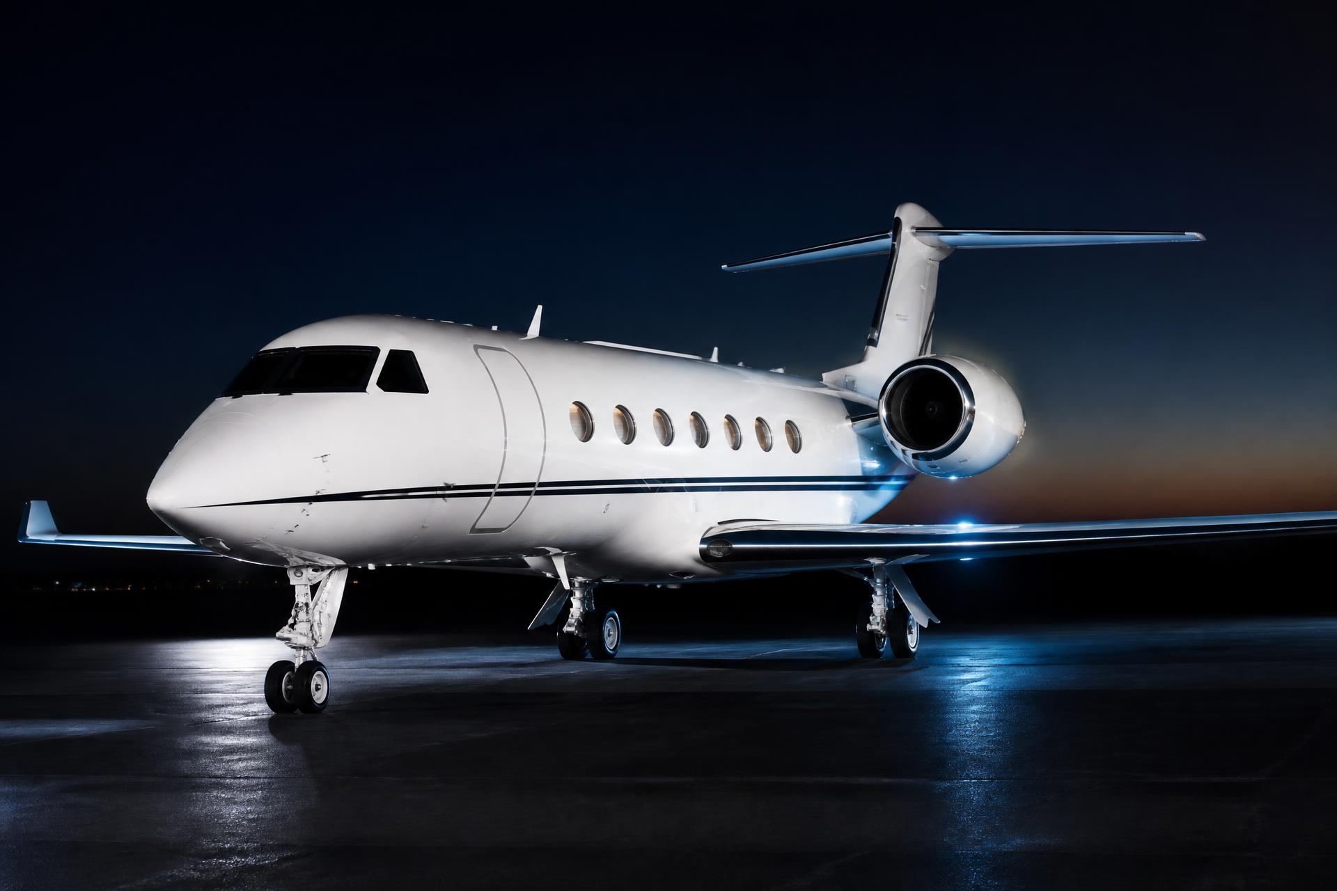 Private jet on tarmac at dusk